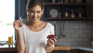 woman eating cherries